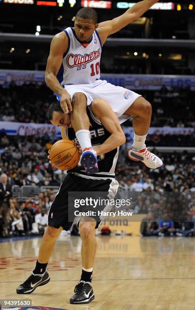 Eric Gordon of the Los Angeles Clippers lands on Manu Ginobili of the San Antonio Spurs attempting to block his shot during the game at Staples...