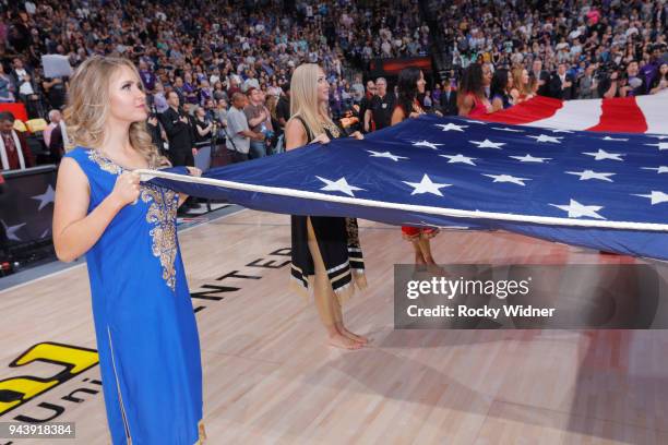 The Sacramento Kings dance team holds up the American flag during the national anthem of the game against the Golden State Warriors on March 31, 2018...