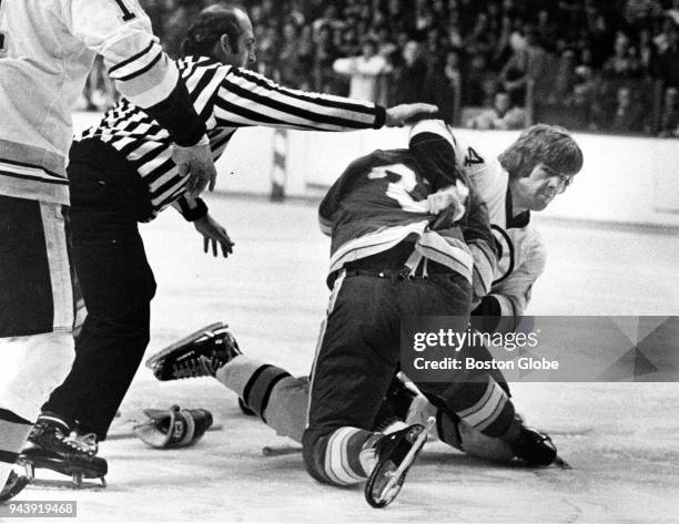 Atlanta Flamers Pat Quinn, left, and Boston Bruins Terry O'Reilly, right, tackle each other during a game at the Boston Garden, Dec. 21, 1975.