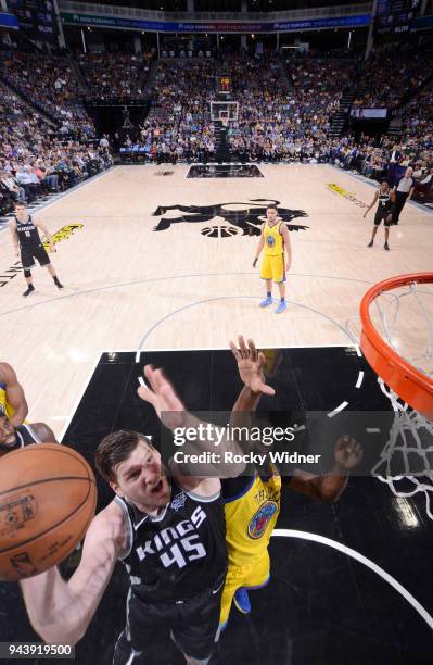 Jack Cooley of the Sacramento Kings shoots a layup against Draymond Green of the Golden State Warriors on March 31, 2018 at Golden 1 Center in...