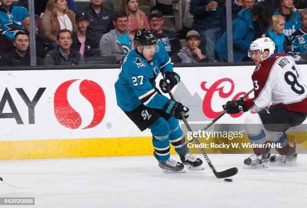 Joonas Donskoi of the San Jose Sharks skates with the puck against Matt Nieto of the Colorado Avalanche at SAP Center on April 5, 2018 in San Jose,...