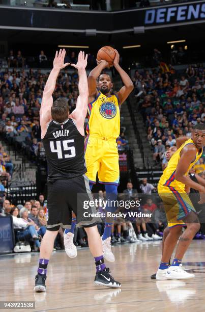 Kevin Durant of the Golden State Warriors shoots a three pointer against Jack Cooley of the Sacramento Kings on March 31, 2018 at Golden 1 Center in...