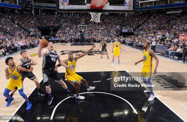 Jack Cooley of the Sacramento Kings rebounds against Kevon Looney of the Golden State Warriors on March 31, 2018 at Golden 1 Center in Sacramento,...