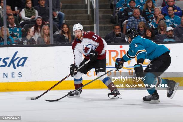 Compher of the Colorado Avalanche skates with the puck against Brenden Dillon of the San Jose Sharks at SAP Center on April 5, 2018 in San Jose,...