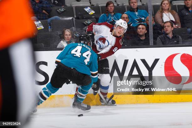 Mikko Rantanen of the Colorado Avalanche passes the puck against Marc-Edouard Vlasic of the San Jose Sharks at SAP Center on April 5, 2018 in San...