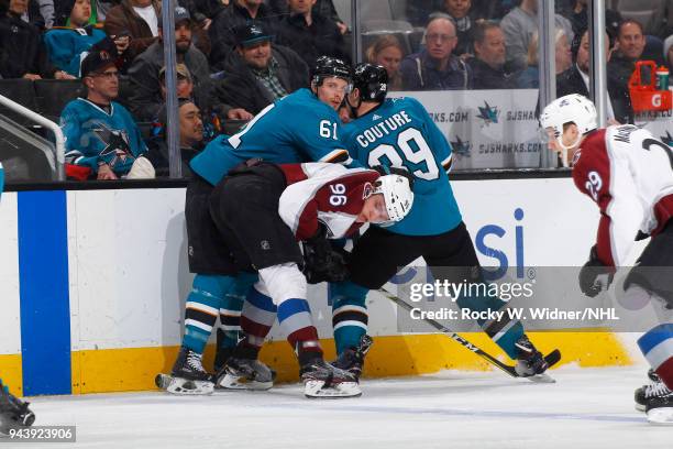 Mikko Rantanen of the Colorado Avalanche skates against Justin Braun and Logan Couture of the San Jose Sharks at SAP Center on April 5, 2018 in San...