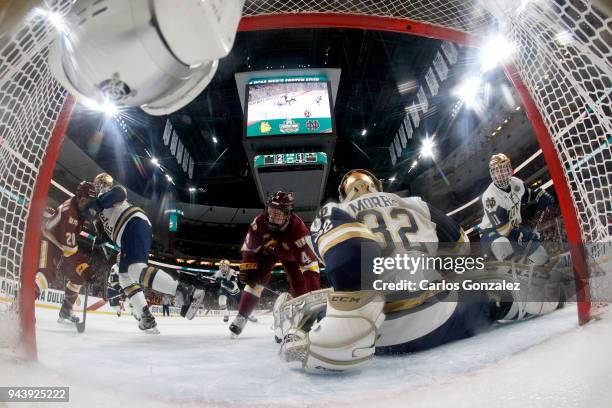 Cale Morris of the Notre Dame Fighting Irish protects the goal against the Minnesota-Duluth Bulldogs during the Division I Men's Ice Hockey...