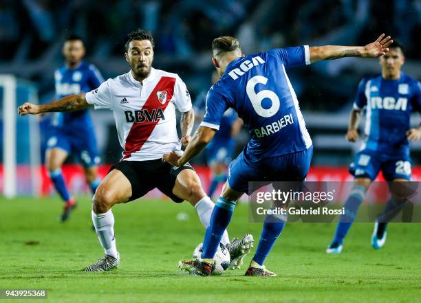 Ignacio Scocco of River Plate fights for the ball with Miguel Barbieri of Racing Club during a match between Racing Club and River Plate as part of...