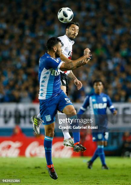Ignacio Scocco of River Plate goes for a header with Nery Dominguez of Racing Club during a match between Racing Club and River Plate as part of...