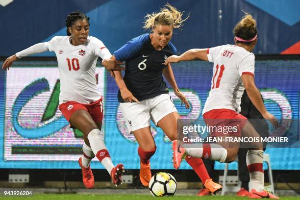 France's midfielder Amandine Henry vies with Canada's defender Ashley Lawrence and Canada's midfielder Desiree Scott during the women's friendly...