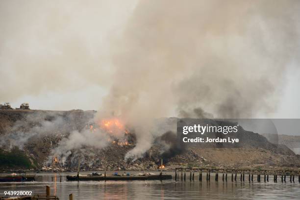 fire burning at scrap-heap - landfill stock pictures, royalty-free photos & images