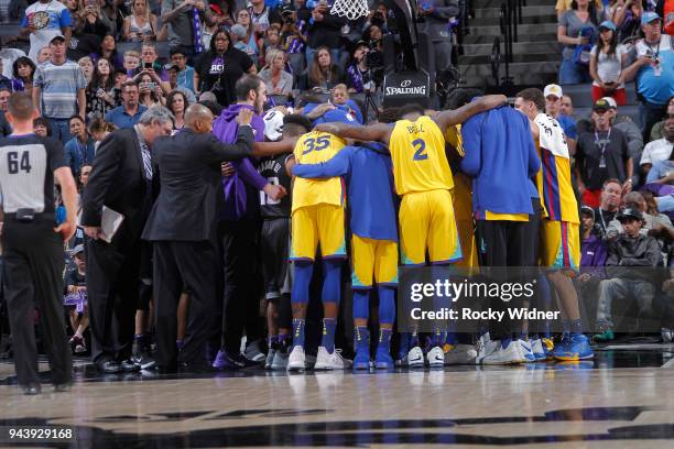 Players of the Golden State Warriors and Sacramento Kings gather together to pray for Patrick McCaw of the Golden State Warriors after exiting the...