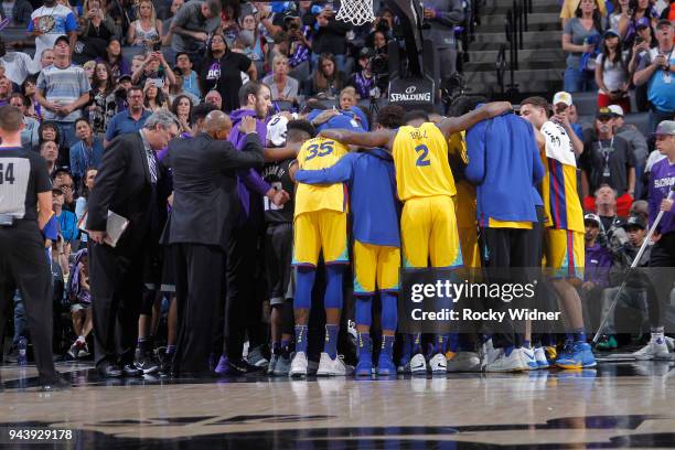 Players of the Golden State Warriors and Sacramento Kings gather together to pray for Patrick McCaw of the Golden State Warriors after exiting the...