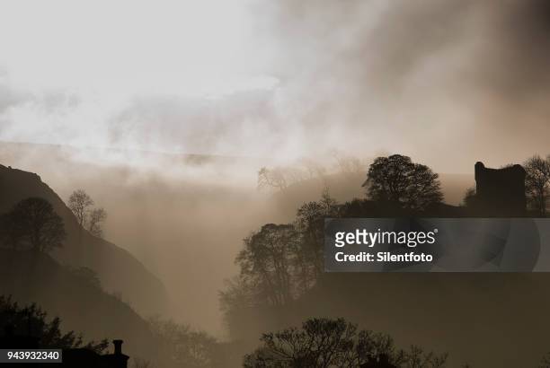 misty landscape with english castle on hill - silentfoto sheffield fotografías e imágenes de stock