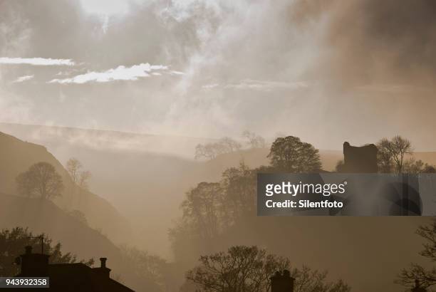 houses rooftops afore misty landscape with english castle - silentfoto sheffield stock pictures, royalty-free photos & images