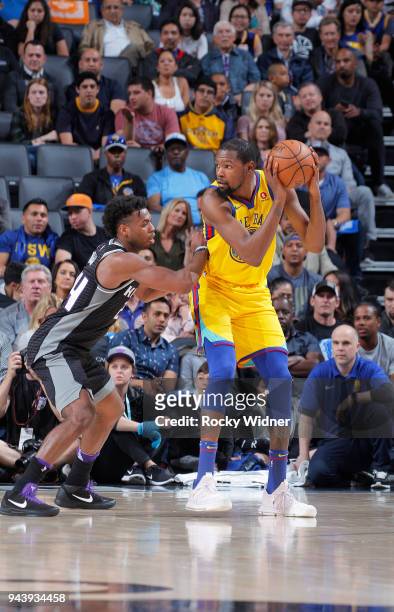 Kevin Durant of the Golden State Warriors handles the ball against Buddy Hield of the Sacramento Kings on March 31, 2018 at Golden 1 Center in...