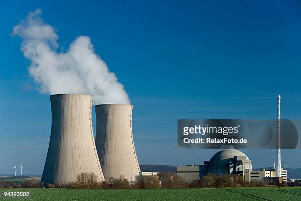 nuclear power station grohnde with steaming cooling towers - nuclear power station stock pictures, royalty-free photos & images