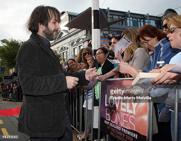 Peter Jackson Director of The Lovely Bones signs autographs as he walks the red carpet during the The Lovely Bones Premiere at the Embassy Theatre on...