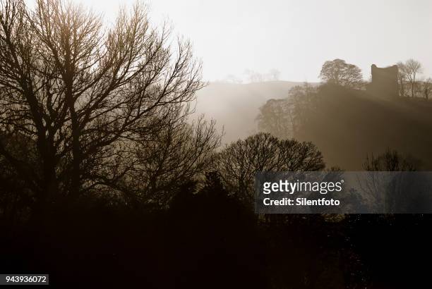 misty landscape with english castle on hill - silentfoto sheffield stock pictures, royalty-free photos & images