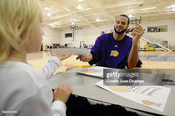 Michael Fey of the Los Angeles D-Fenders signs an autograph for a young fan after the game against the Idaho Stampede on December 13, 2009 at the...