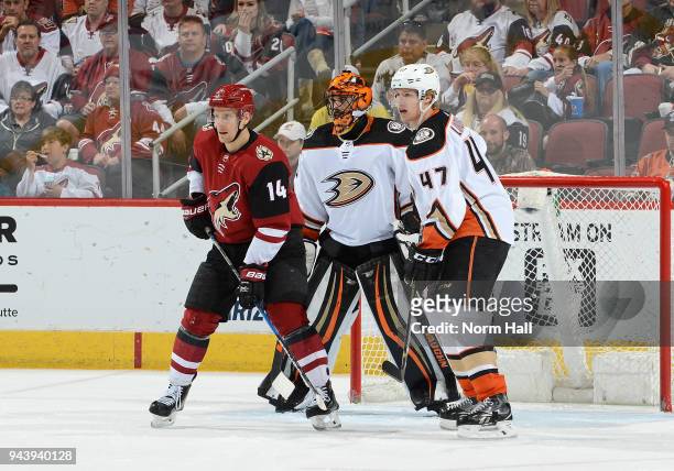 Richard Panik of the Arizona Coyotes looks for the puck while battling for position between Ryan Miller and Hampus Lindholm of the Anaheim Ducks at...