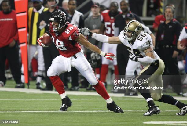 Tony Gonzalez of the Atlanta Falcons runs with a catch against Scott Shanle of the New Orleans Saints at the Georgia Dome on December 13, 2009 in...