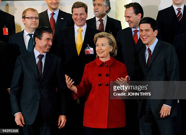 Secretary of State Hillary Clinton speaks with NATO Secretary General Anders Fogh Rasmussen and Britain's foreign secretary David Miliband , German...