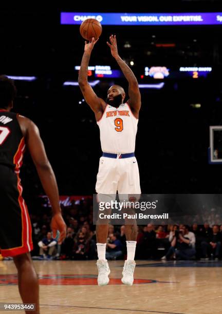 Kyle O'Quinn of the New York Knicks shoots and sinks a three point shot in an NBA basketball game against the Miami Heat on April 6, 2018 at Madison...
