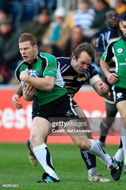 Liam Bibo of Connaught Rugby is tackled by Chris Pennell of Worcester Warriors during the Amlin Challenge Cup match between Worcester Warriors and...