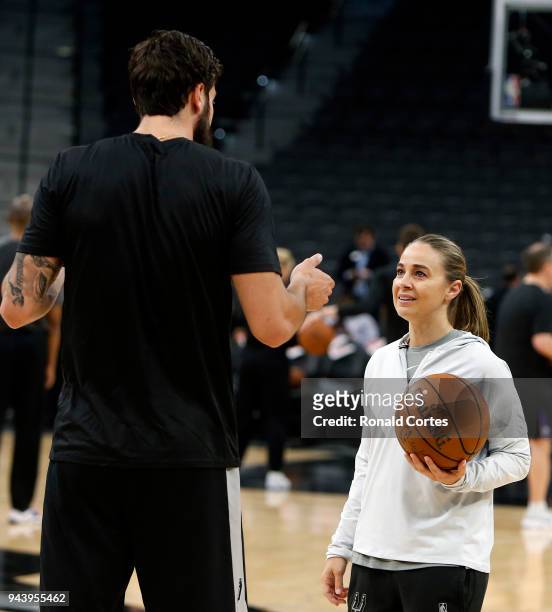 Joffrey Lauvergne of the San Antonio Spurs works with assistant coach Becky Hammond before the start of their game against the Sacramento Kings at...