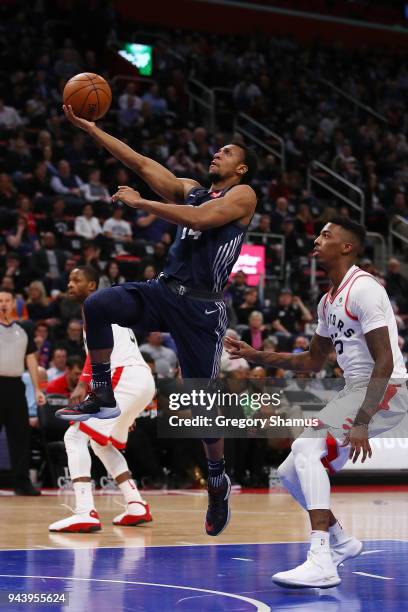 Ish Smith of the Detroit Pistons drives to the basket past Delon Wright of the Toronto Raptors during the first half at Little Caesars Arena on April...