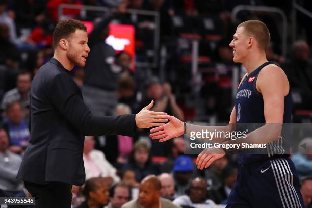 Blake Griffin of the Detroit Pistons celebrates with Henry Ellenson after a Toronto Raptors first half timeout at Little Caesars Arena on April 9,...