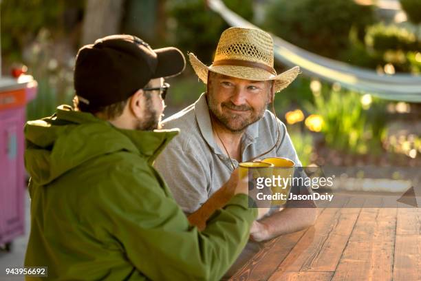 happy smiling mid adult man drinking coffee - jasondoiy imagens e fotografias de stock