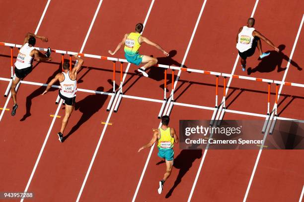 Athletes clear a hurdle in the Men's Decathlon 110 metres hurdles heats during the Athletics on day six of the Gold Coast 2018 Commonwealth Games at...