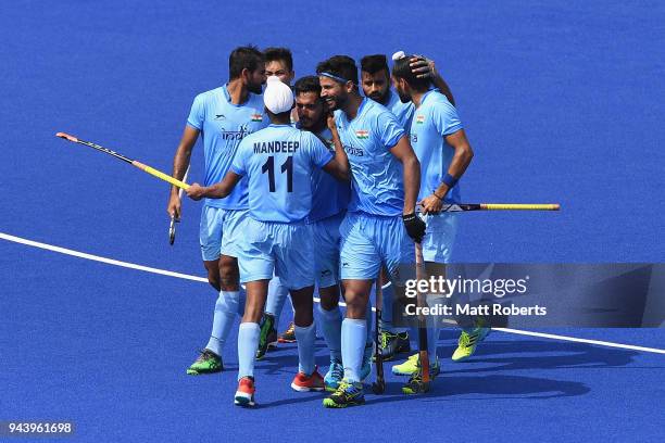 Harmanpreet Singh of India celebrates scoring a goal with team mates during the Hockey Men's Pool B match between India and Malaysia on day six of...