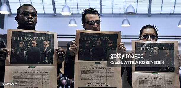 Activists show a page of the Today's edition of the British newspaper Financial Times showing US President Barack Obama, Japanese Prime Minister...