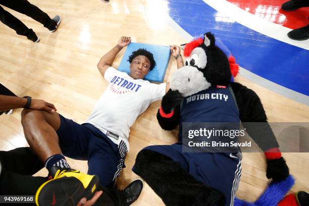 Stanley Johnson of the Detroit Pistons stretches with mascot Hooper of the Detroit Pistons before the game against the Toronto Raptors on April 9,...