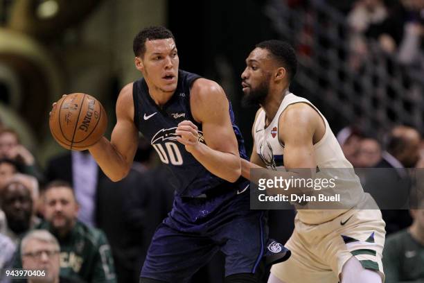 Aaron Gordon of the Orlando Magic dribbles the ball while being guarded by Jabari Parker of the Milwaukee Bucks in the first quarter at the Bradley...