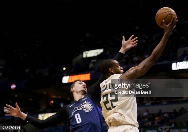 Khris Middleton of the Milwaukee Bucks attempts a shot while being guarded by Mario Hezonja of the Orlando Magic in the first quarter at the Bradley...