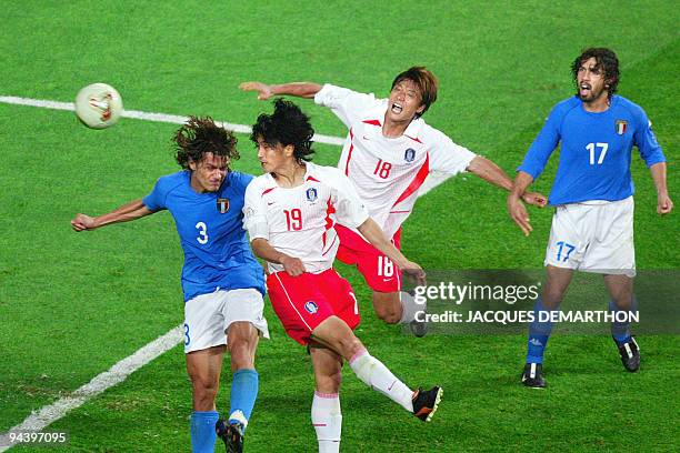 South Korean midfielder Ahn Jung-hwan heads the ball past Italian defender Paolo Maldini for a 'golden goal' in their second round match at the 2002...