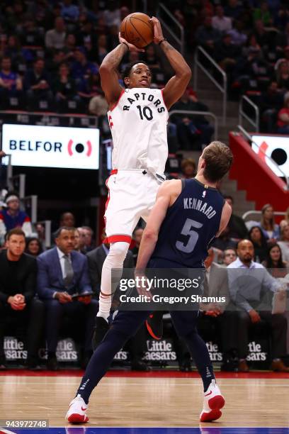 DeMar DeRozan of the Toronto Raptors takes a shot over Luke Kennard of the Detroit Pistons during the second half at Little Caesars Arena on April 9,...