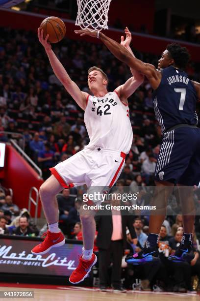 Jakob Poeltl of the Toronto Raptors gets to the rim past Stanley Johnson of the Detroit Pistons during the second half at Little Caesars Arena on...
