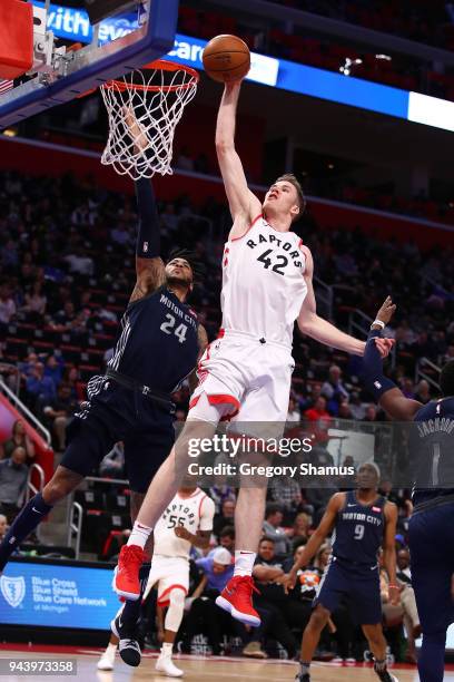Jakob Poeltl of the Toronto Raptors drives to the basket past Reggie Jackson of the Detroit Pistons during the second half at Little Caesars Arena on...