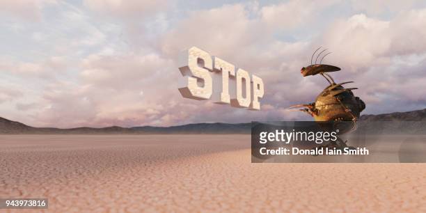 stop: sign with light bulbs floating in desert with robot patiently waiting - kvardröjande bildbanksfoton och bilder