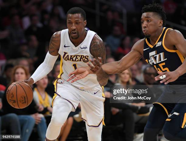 Kentavious Caldwell-Pope of the Los Angeles Lakers drives past Donovan Mitchell of the Utah Jazz in the first half at Staples Center on April 8, 2018...