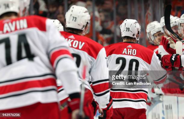 Sebastian Aho of the Carolina Hurricanes celebrates a first period goal with teammates on the bench against the Philadelphia Flyers on April 5, 2018...