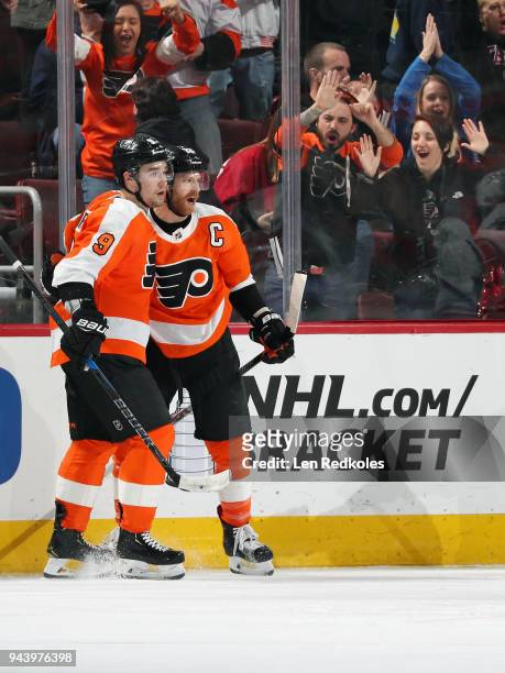 Claude Giroux of the Philadelphia Flyers reacts with Ivan Provorov after his third period goal against the Carolina Hurricanes on April 5, 2018 at...