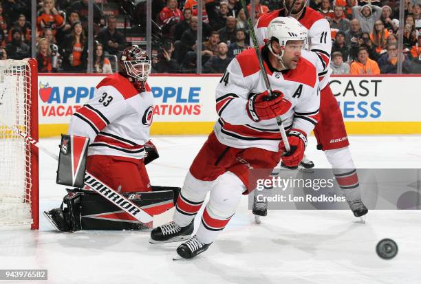 Justin Williams and Scott Darling of the Carolina Hurricanes react to the airborne puck against the Philadelphia Flyers on April 5, 2018 at the Wells...