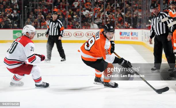 Nolan Patrick of the Philadelphia Flyers skates the puck against Sebastian Aho of the Carolina Hurricanes on April 5, 2018 at the Wells Fargo Center...