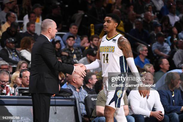 Gary Harris and Michael Malone of the Denver Nuggets high five during the game against the Portland Trail Blazers on APRIL 9, 2018 at the Pepsi...